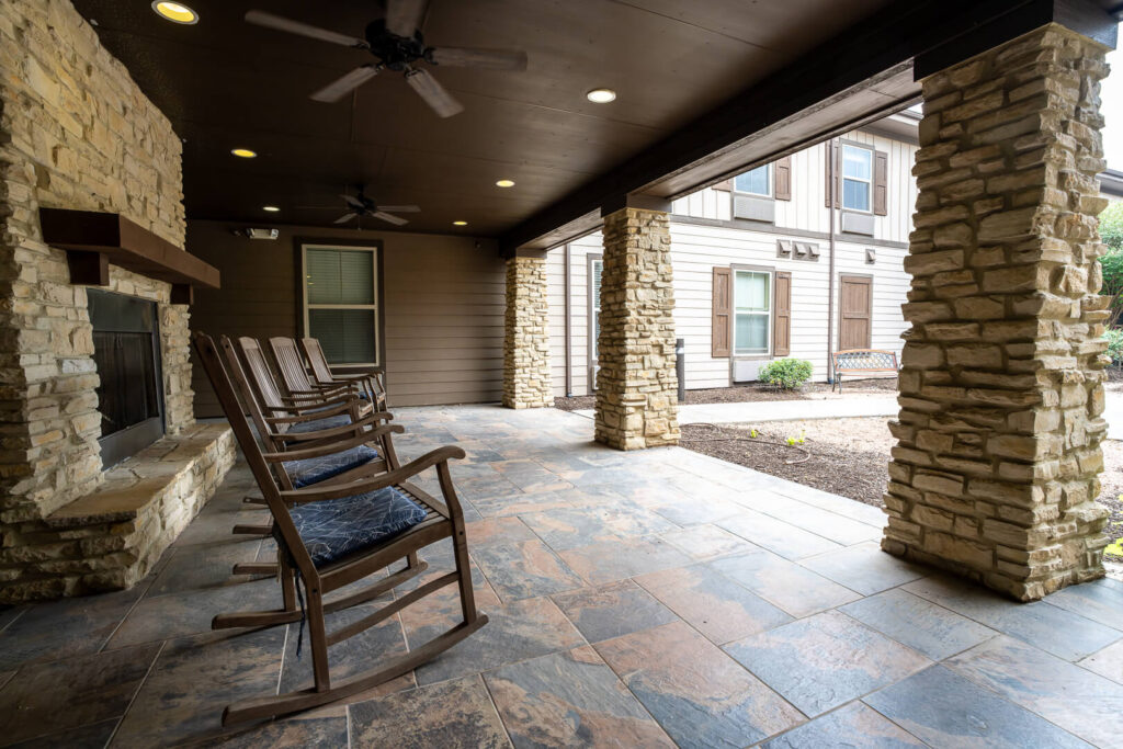 Covered Patio with Rocking Chairs for Elderly at Assisted Living Memory Care