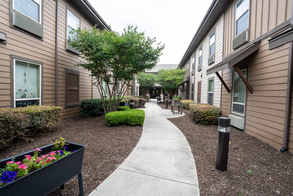 Landscaped Courtyard Walkway Between Buildings at Assisted Living in San Antonio