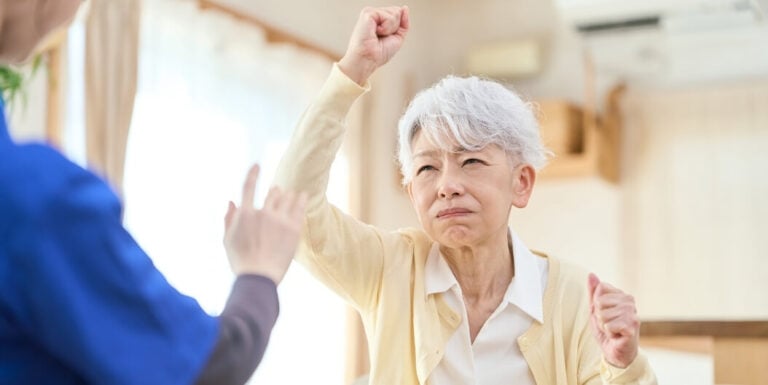 Frustrated Elderly Woman Facing Nursing Staff at Assisted Living Facility